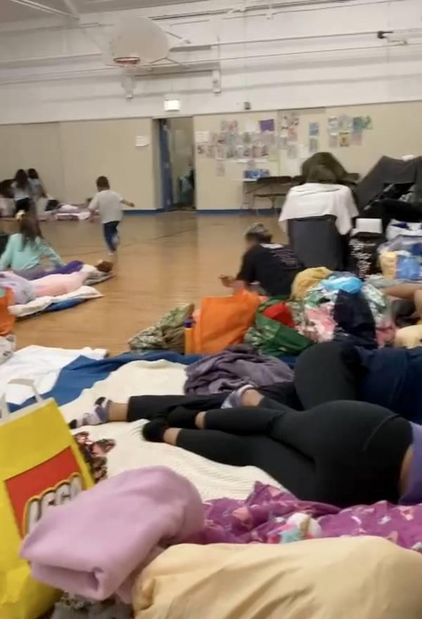 A still image from a WhatsApp video sent to the Tribune on May 25 by an ano<em></em>nymous source shows migrants sleeping on the floor of a gymnasium in the Leone Beach Park shelter. 