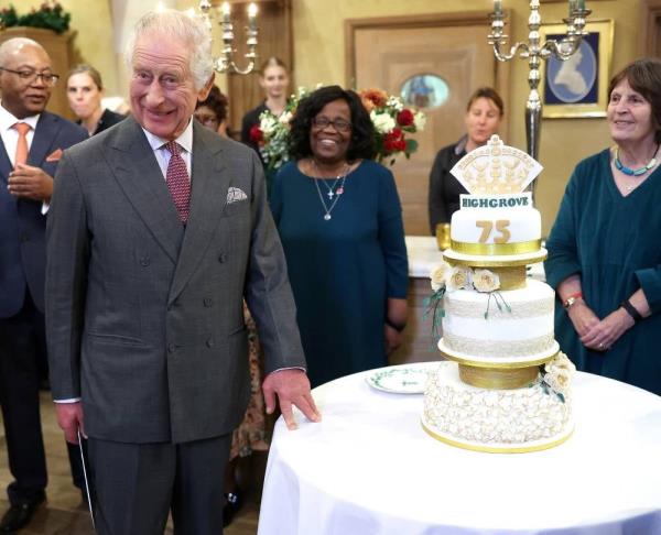 Britain's King Charles III reacts whils holding a knife as he prepares to cut a birthday cake as he attends his 75th birthday party, hosted by the Prince's Foundation, at Highgrove House in Tetbury, western England on Nov 13, 2023. (Photo by Chris Jackson / POOL / AFP)