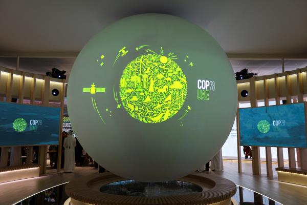 A view shows the 'Cop28 UAE' logo on a globe, during Abu Dhabi Sustainability Week (ADSW), in Abu Dhabi
